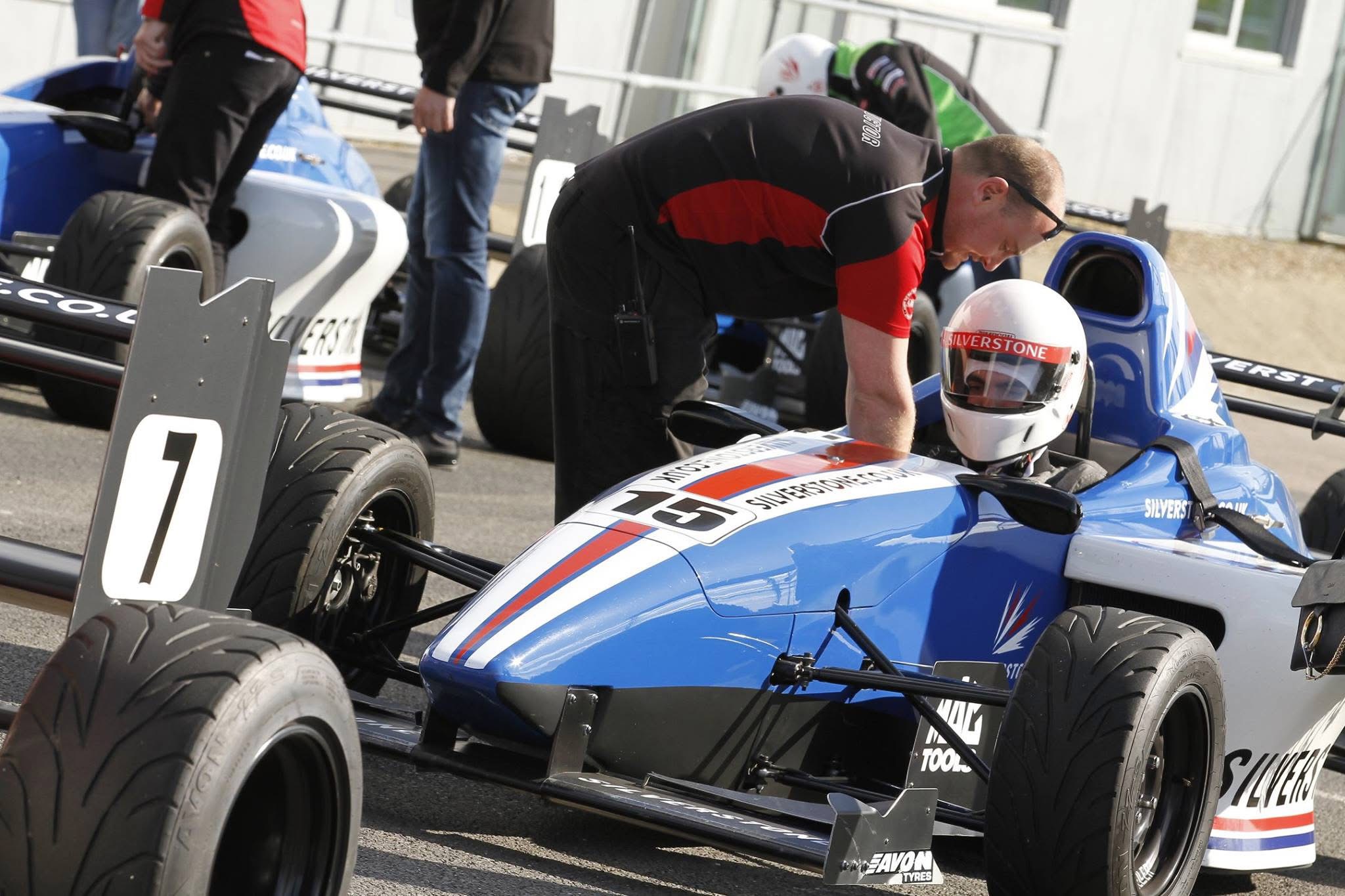 Alex Karim seated in a Formula racing car during a track driving experience