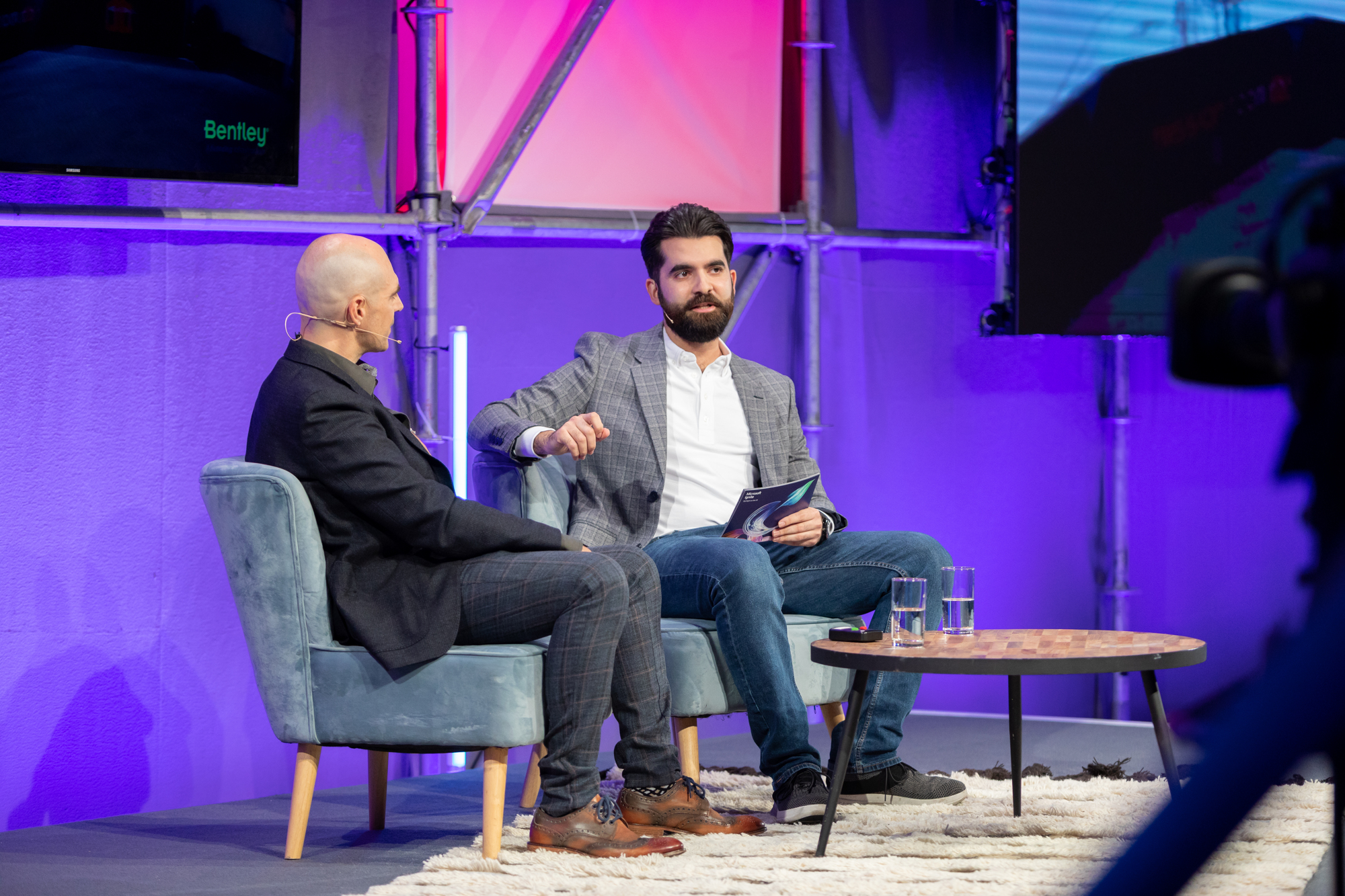 Alex Karim in conversation on stage during a keynote